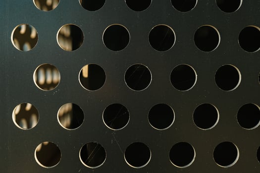 Abstract shiny metal background in silver color with round holes texture. Perforated metal background photo
