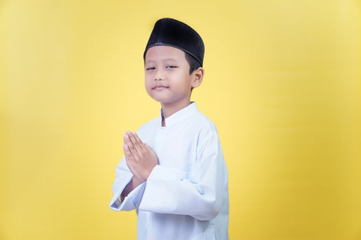 a young boy in a traditional muslim outfit photo
