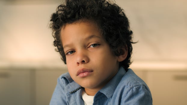 Close up portrait little sad pensive kid African American ethnic boy son cute offended punished child alone male baby schoolboy toddler pupil orphan upset face at home worry children custody adoption photo
