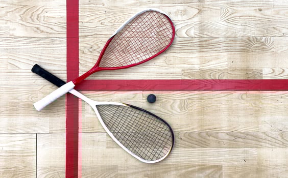 Sports, above and racket on squash court for competition, challenge and training center. Exercise, interior and empty room with top view of wooden floor of gymnasium for games, fitness club and gear photo