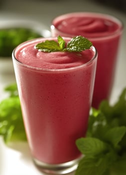 Refreshing berry smoothie served in clear glasses with mint garnish in a bright kitchen setting photo