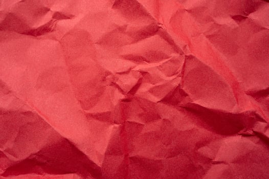 Full frame shot of crumpled red paper sheet texture and background. photo