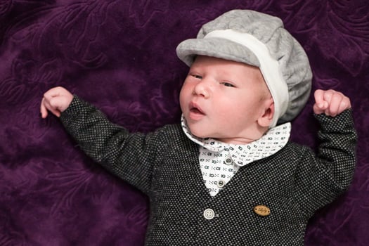 A baby wearing a hat and a suit photo