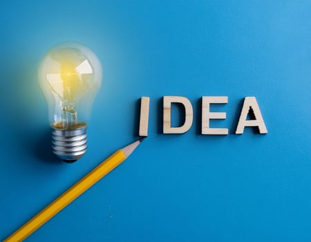 Pencil with Light Bulb and 'Idea' Word on Blue Background photo