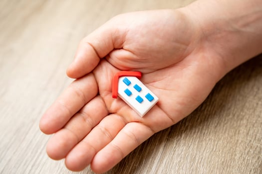 Save your home. Insurance agent protects the house with a gesture of protection. photo
