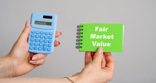 Fair Market Value concept. Price an asset would sell for on the open market when certain conditions are met. Business and finance. Calculator and notebook in hands photo