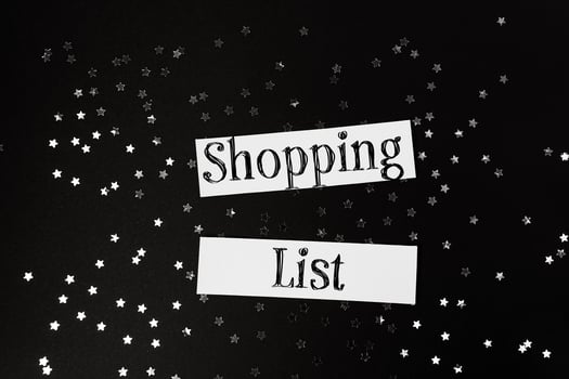Shopping list is written on a piece of paper with stars scattered around it photo