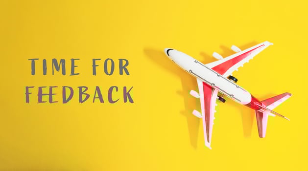 Small airplane is on a yellow background with the words Time for feedback photo