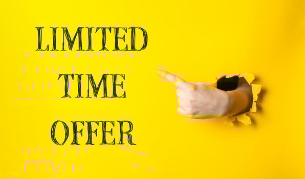 A hand pointing to a yellow background with the words limited time offer photo