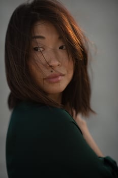 The beauty mark above her upper lip adds character to her radiant, sun-kissed face. photo