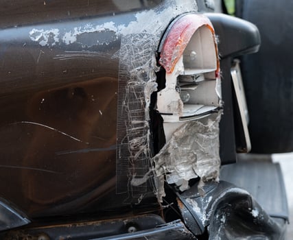 Severely damaged vehicle rear quarter panel and taillight. photo