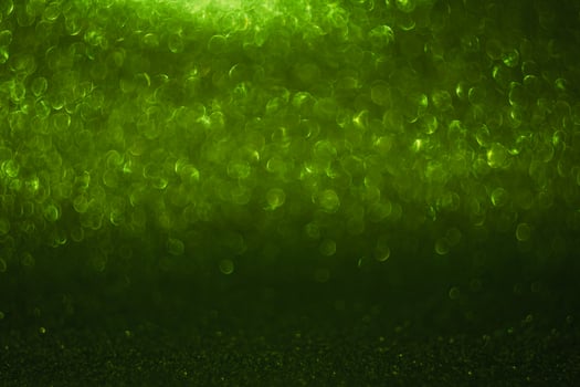 A green background with a lot of blurry dots photo