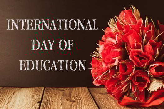 a wooden table with the words International Day of Education photo