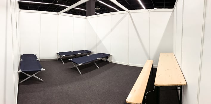 Room with a bench and two beds, refugee camp in Cologne photo