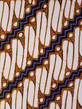 Batik pattern background. A close up of Javanese batik with a Parang Srimpi pattern. Indonesian batik photo