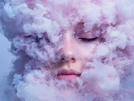 Mysterious womans face obscured by ethereal purple smoke photo
