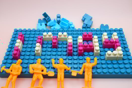 Toy Bricks Spelling 1 May with Mini Workers Labor Day Symbol photo