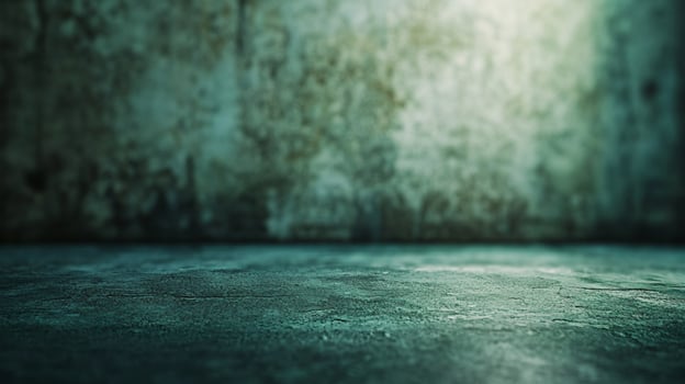 An empty room with a green wall and concrete floor photo