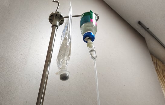IV bags and paracetamol hanging in the hospital room. Healing medicine and patient care photo