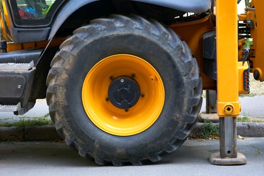 Lifting machine truck crane stands on stops, a large wheel of a tractor photo
