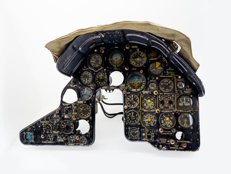 A detailed view of a Soviet aircraft cockpit instrument panel, showcasing an array of gauges, switches, and controls. This intricate setup highlights the precision engineering and functionality of mid photo