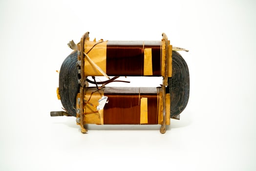 Electric motor coil displayed on white background for inspection photo