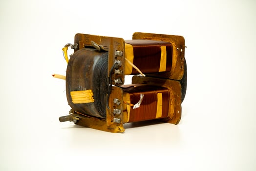 Electric coil assembly with copper windings and yellow insulation photo