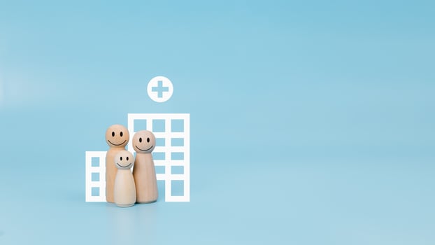 Health insurance and medical care concept, Family health insurance concept, Family doll with hospital symbol on blue background, Health care life insurance concept, Hospital life insurance concept. photo