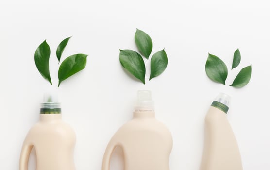 Choose bio concept. Different liquid detergents for wet home cleaning with quality and safety sign natural leaves, white background photo