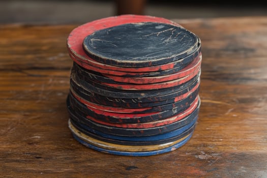 A stack of four red, blue, and black coasters photo