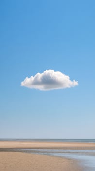A cloud floating in the sky above a beach photo