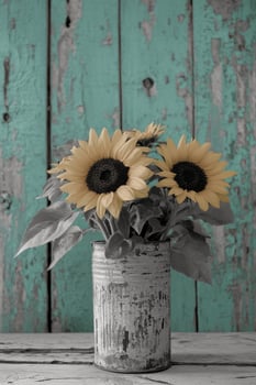 A black and white photo of sunflowers in a vase