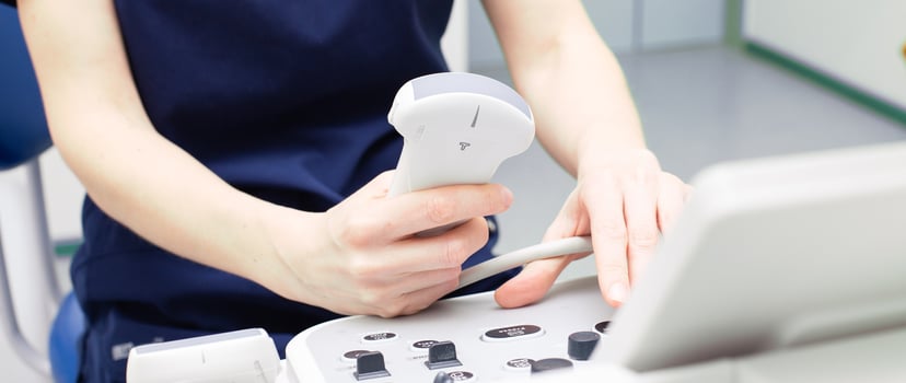 doctor sitting in office in a hospital doing ultrasound scanning diagnostic photo