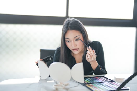 a woman is looking at her makeup and makeup photo