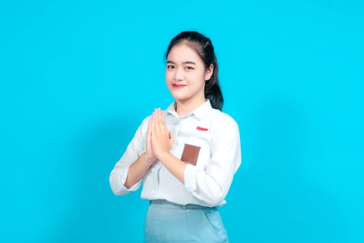 Student gesturing Welcome Against a Vibrant Blue Background photo