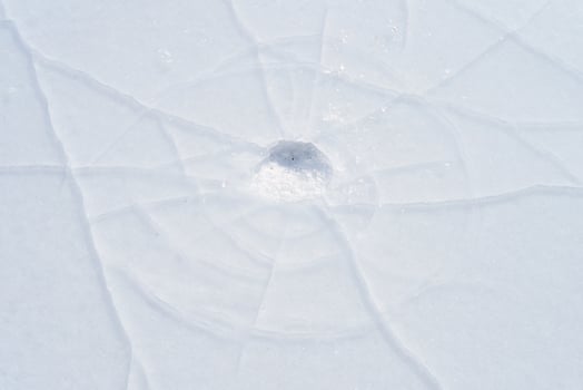 Cracks in the ice of a frozen river in winter photo