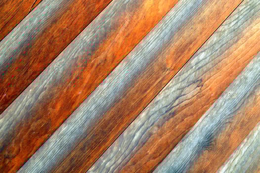Wooden wall made of diagonal boards with light gray stripes. background photo