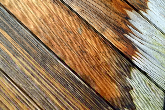 Wooden wall made of diagonal boards with white painted spots. background photo