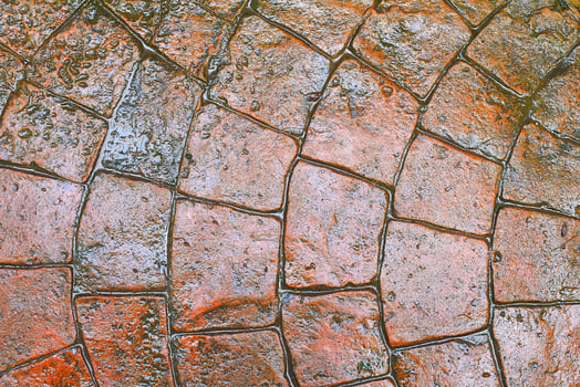 Orange wet tiles background. Copy space photo