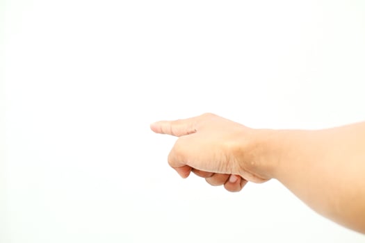 A human hand points toward the left side against plain white background direction for concepts photo