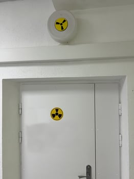 Radiation hazard sign on door indicating restricted area in laboratory or facility photo