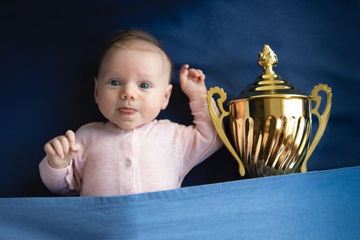 baby with golden cup victory photo