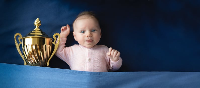 baby with golden cup victory panoramic photo