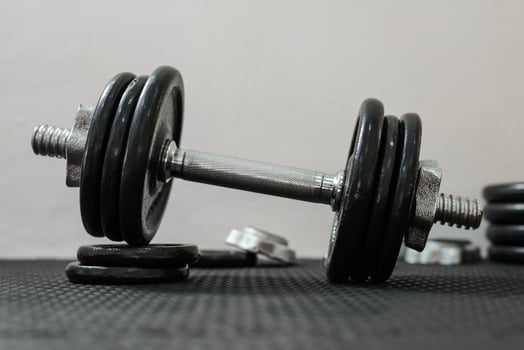 Iron dumbbells or weights on black floor in the gym. Weight Training Equipment. Health care concept. photo