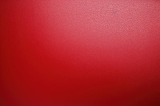 Red leather texture background showing grain and creases photo