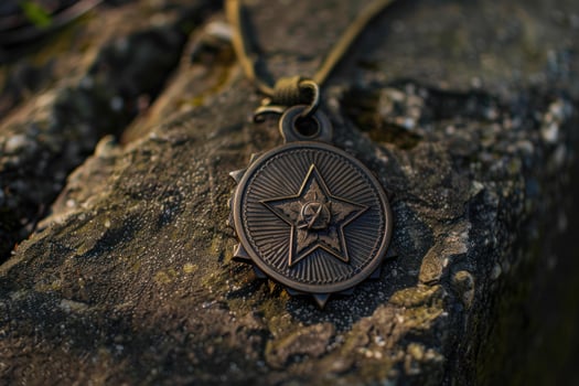 Old soviet order of the red star military medal laying on stone surface photo