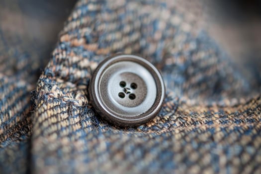 Close up photography of button on woolen clothing photo