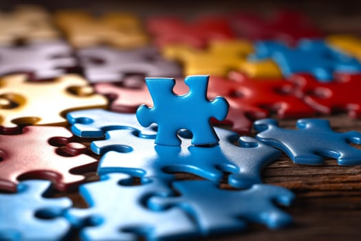 Blue puzzle piece standing out among colorful jigsaw pieces photo