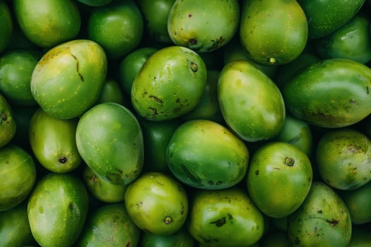 Fresh green mangoes forming a vibrant tropical fruit background photo