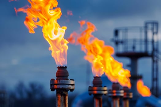 Gas flares burning at a processing plant at dusk photo